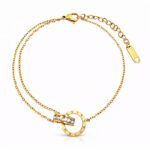 Gold-plated dual-chain bracelet with Roman numerals and cubic zirconia centerpiece