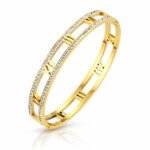 Gold cuff bracelet with Roman numeral cutouts and cubic zirconia accents
