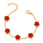 Gold-plated bracelet with red clover charms on a white background