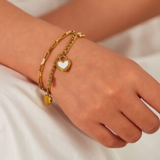 Gold plated heart charm bracelet worn on a wrist